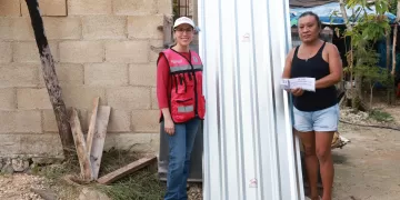 Atenea Gómez Ricalde entrega láminas de zinc casa por casa en Ciudad Mujeres